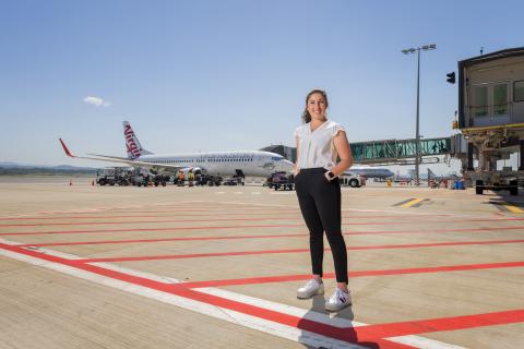 Tara Khan stands on the tarmac