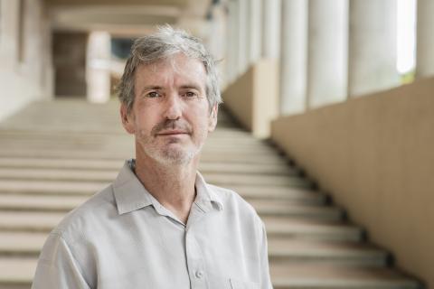 Dr Bruce Watt smiling near the library steps