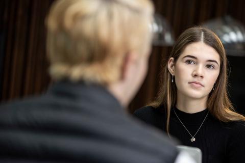 Two people sitting and looking at each other