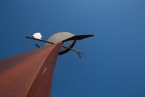 Orange and grey statue with a blue sky