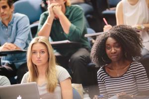 Two students in a lecture theatre